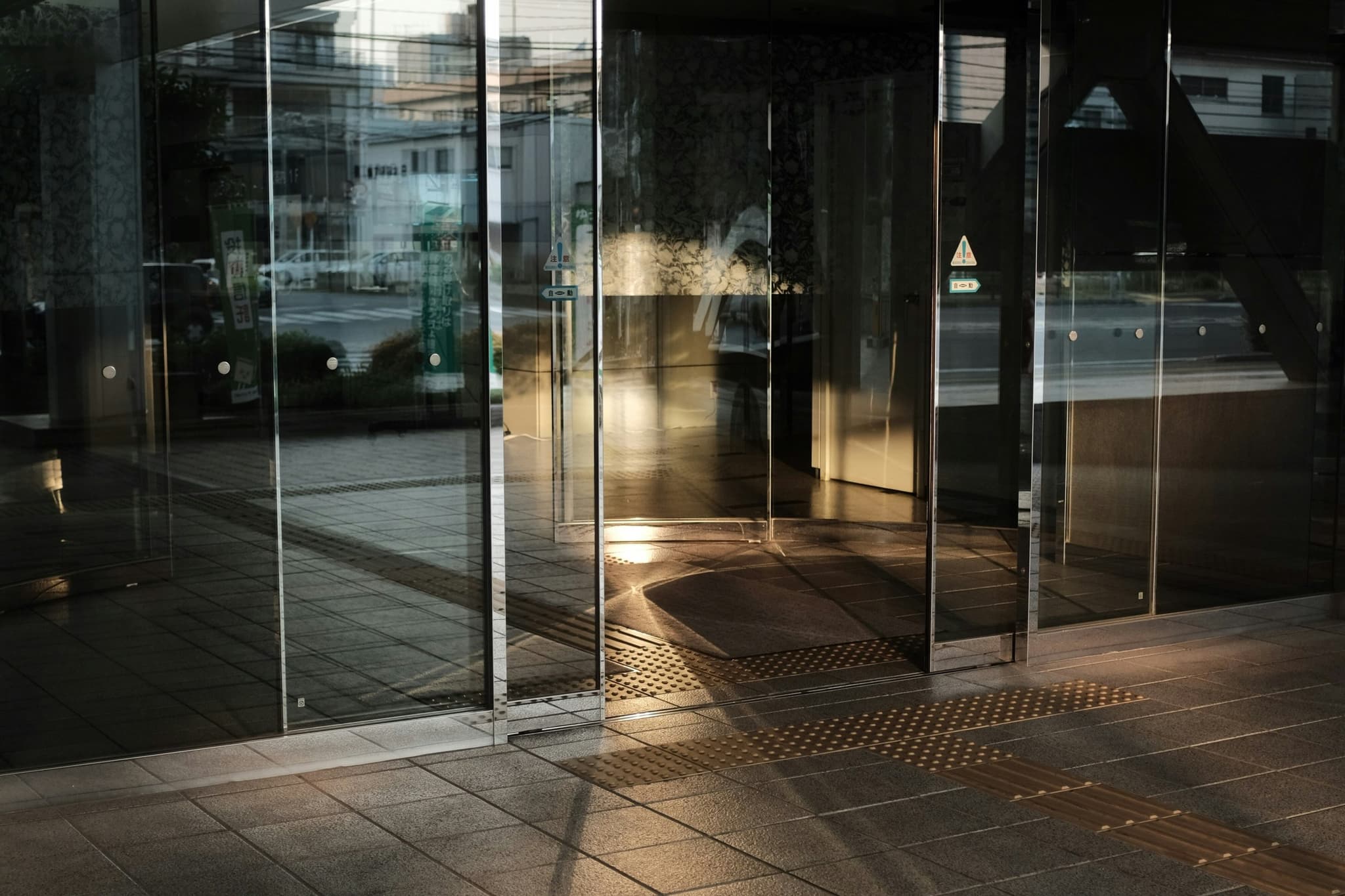 Modernised glass automatic entrance at a commercial building lobby